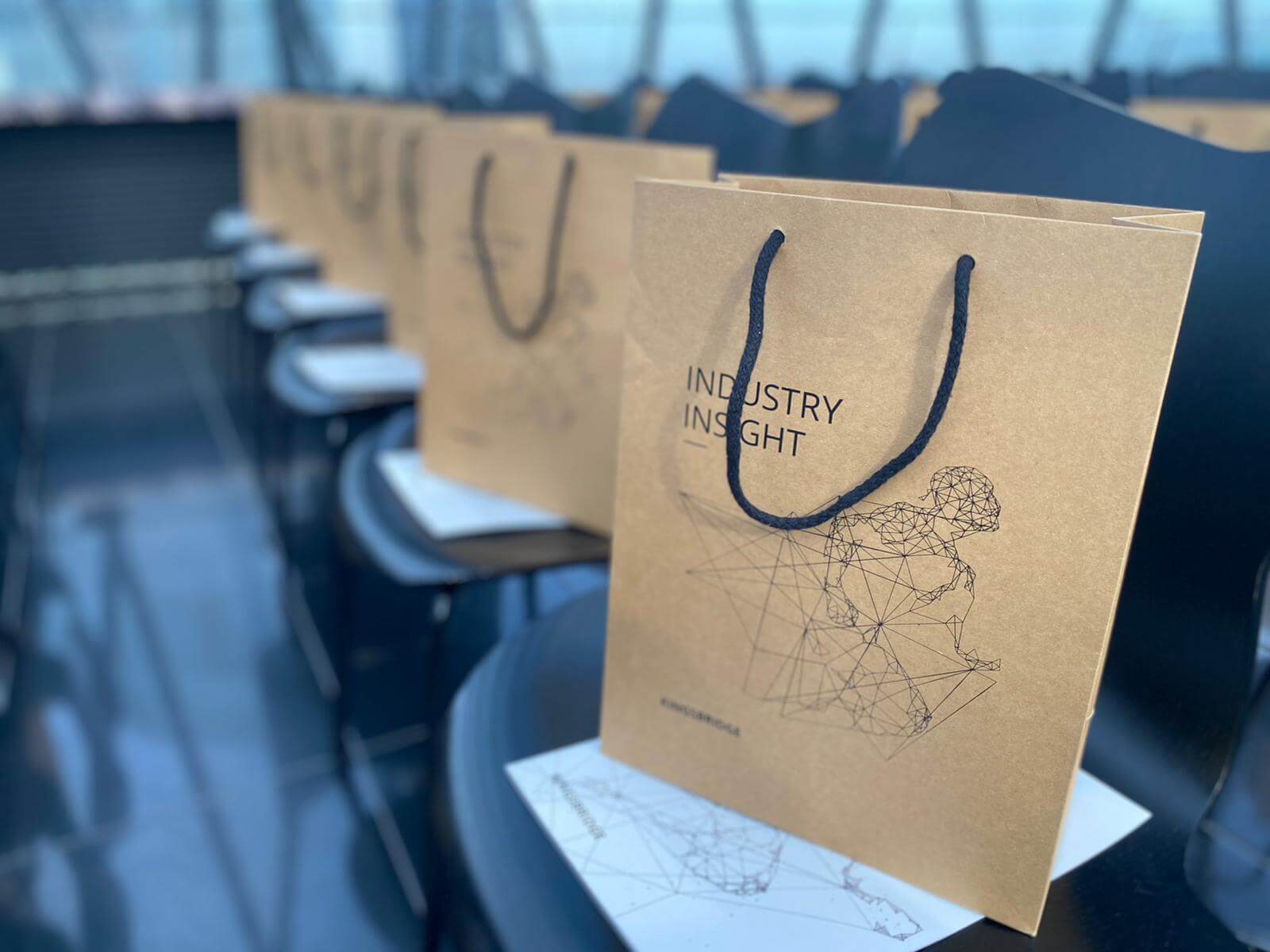 Close up of goody bags on chairs at the Industry Insight event