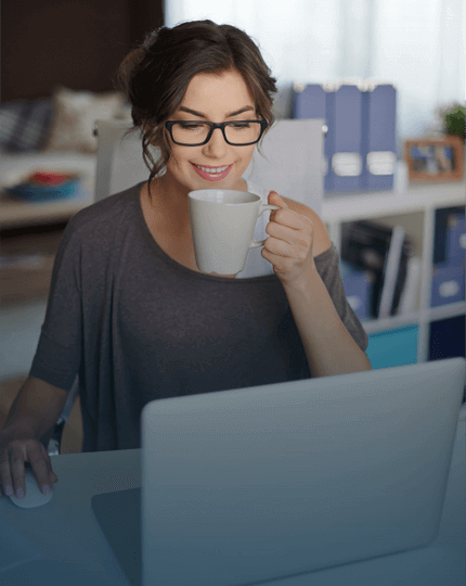 woman-at-desk-drinking-cup-of-tea