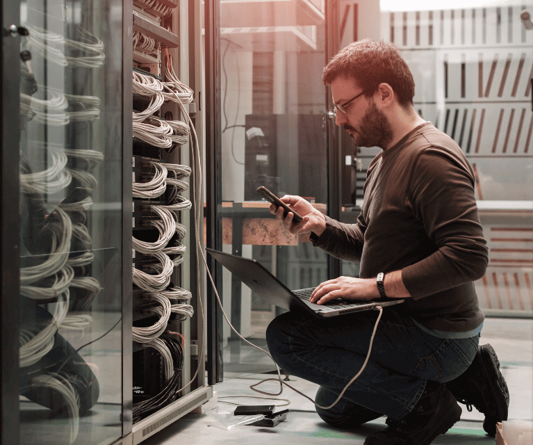 Male IT freelancer working in a server room