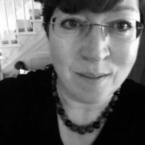 Elaine Richardson, experienced IT consultant and former contractor who won an IR35 case against HMRC, wearing glasses and a beaded necklace in a black-and-white portrait.