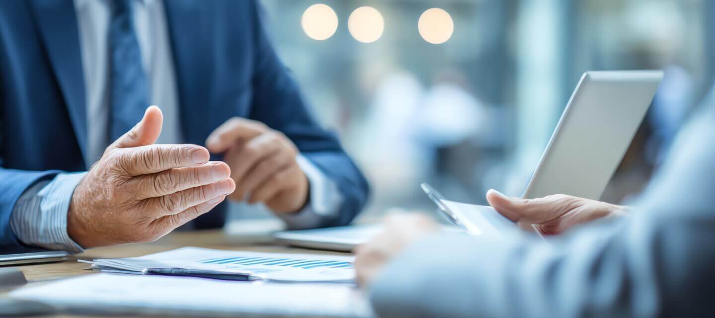 Business owner discussing small business insurance costs with an advisor during a consultation